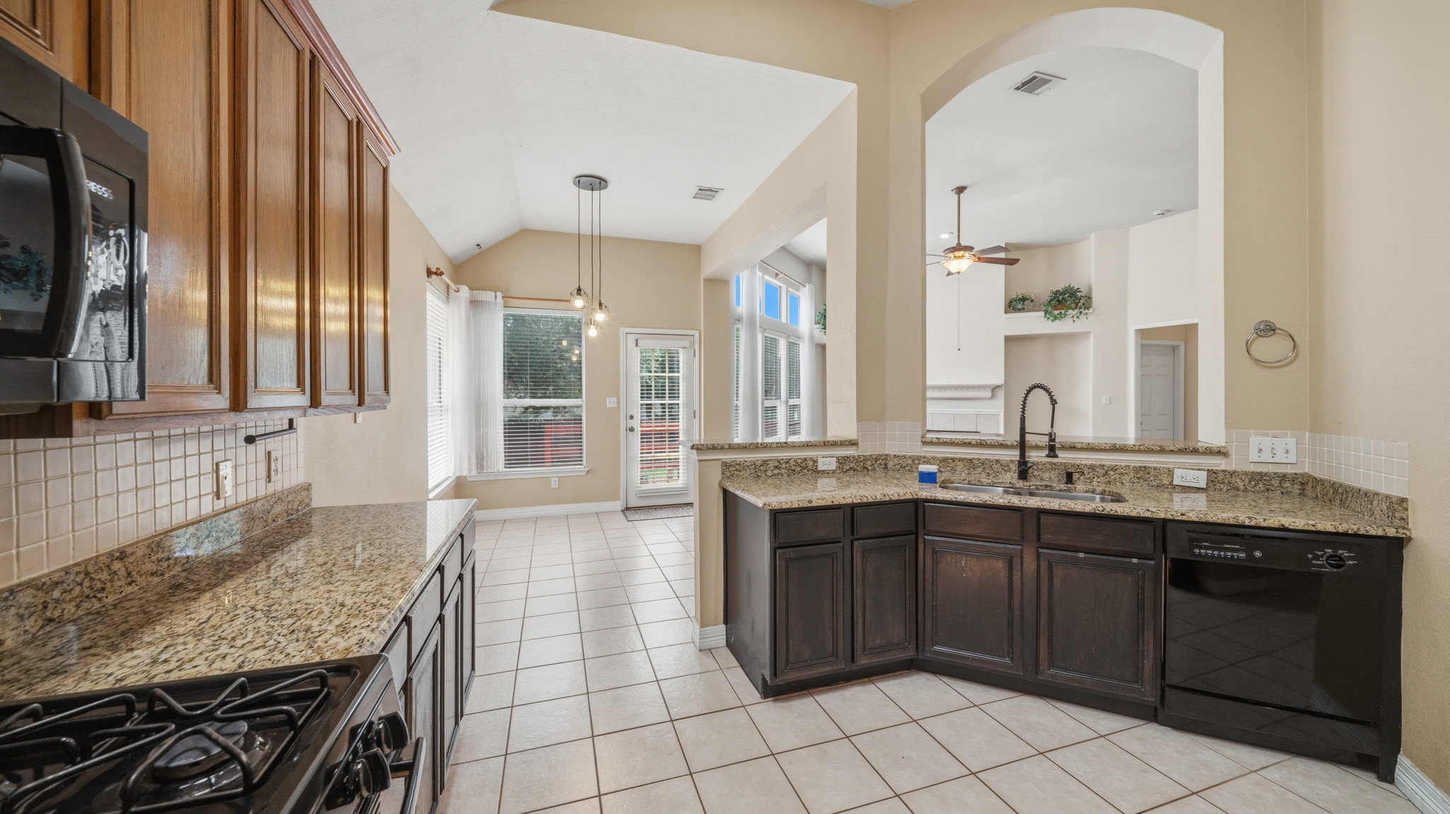 1108 Antelope Ridge Cedar Park, TX 78613 - Photo 7 of 27 A well-appointed kitchen showcasing durable granite countertops and tile flooring, perfect for daily living.