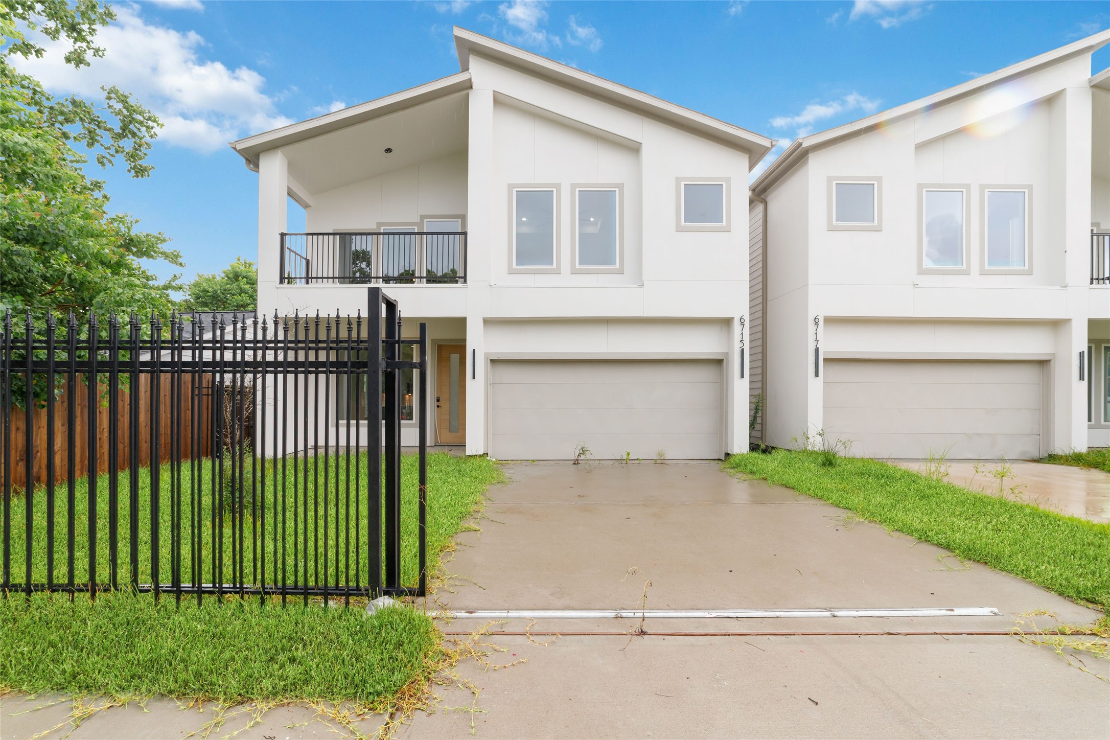 a front view of a house with a garden and plants