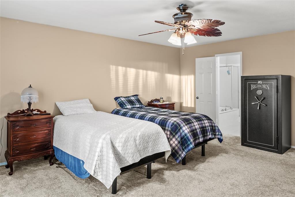 1413 Rodeo Drive Murphy, TX 75094 - Photo 12 of 29 a bedroom with a bed and a chandelier