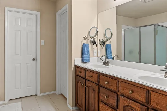 a bathroom with a double vanity sink and a mirror
