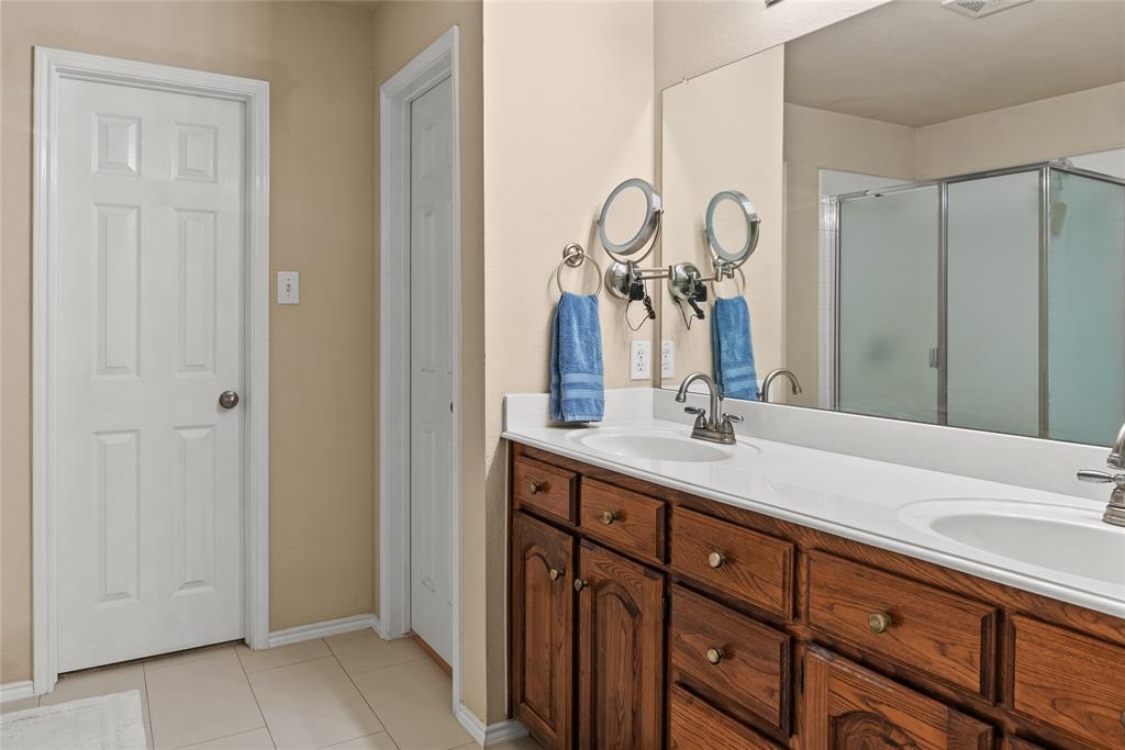 1413 Rodeo Drive Murphy, TX 75094 - Photo 13 of 29 a bathroom with a double vanity sink and a mirror