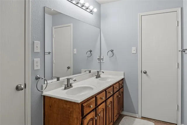 a bathroom with a sink a mirror and a vanity