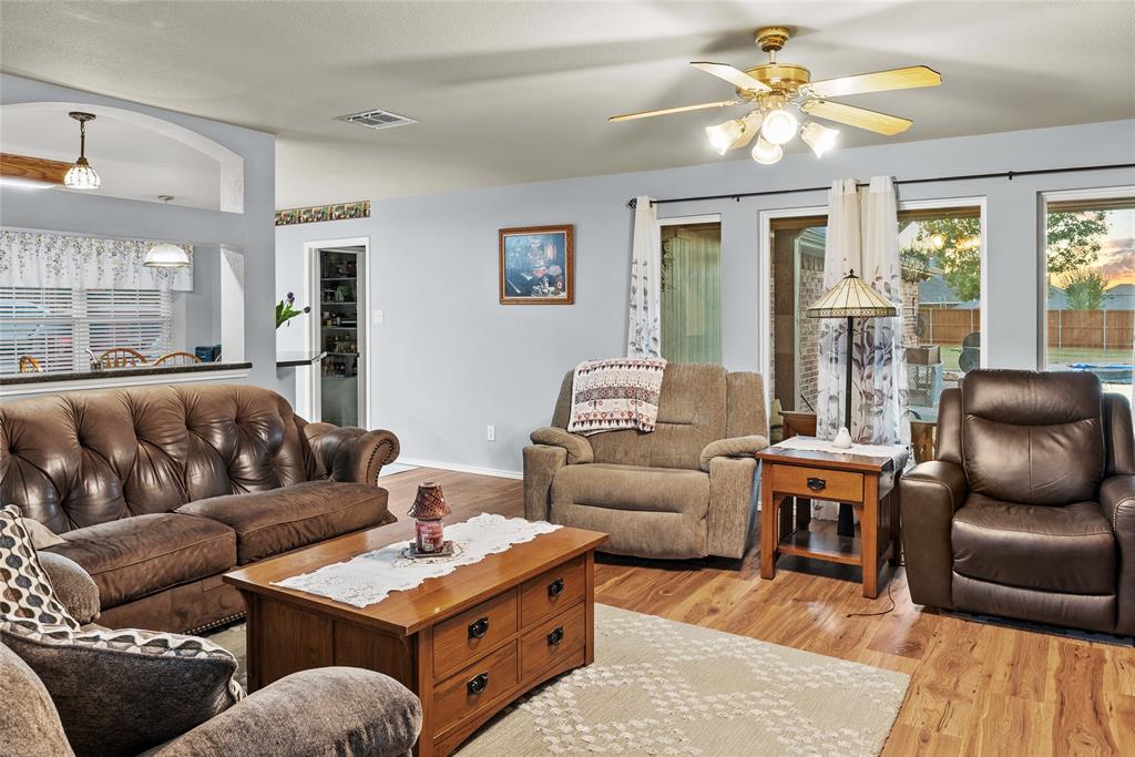1413 Rodeo Drive Murphy, TX 75094 - Photo 3 of 29 a living room with furniture a table and a chandelier