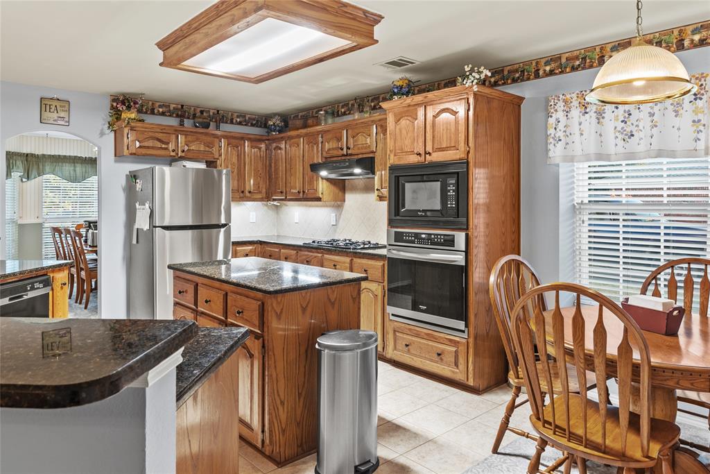 1413 Rodeo Drive Murphy, TX 75094 - Photo 6 of 29 a kitchen with stainless steel appliances granite countertop a sink a stove and a refrigerator