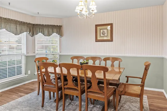 a view of a dining room with furniture and chandelier