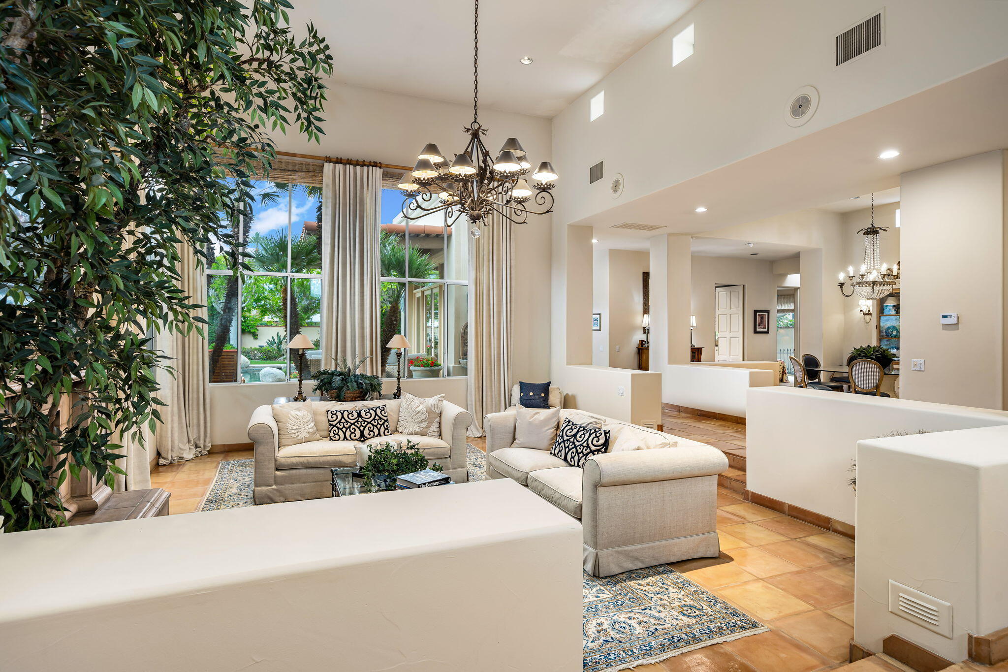 45595 Apache Road Indian Wells, CA 92210 - Photo 12 of 58 a living room with furniture a chandelier and a large window