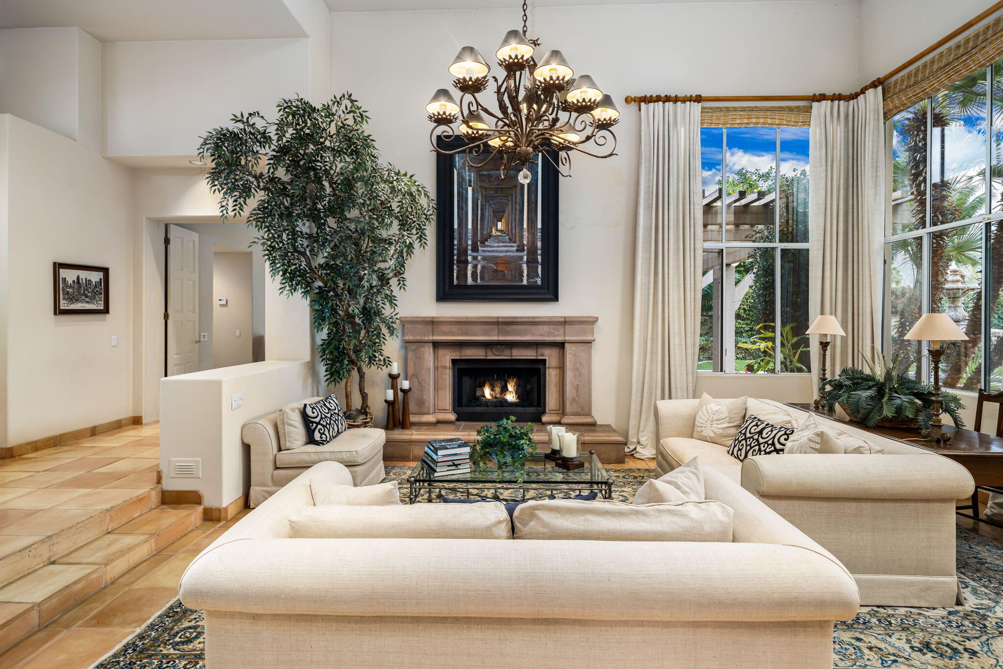 45595 Apache Road Indian Wells, CA 92210 - Photo 13 of 58 a living room with furniture a fireplace and a chandelier