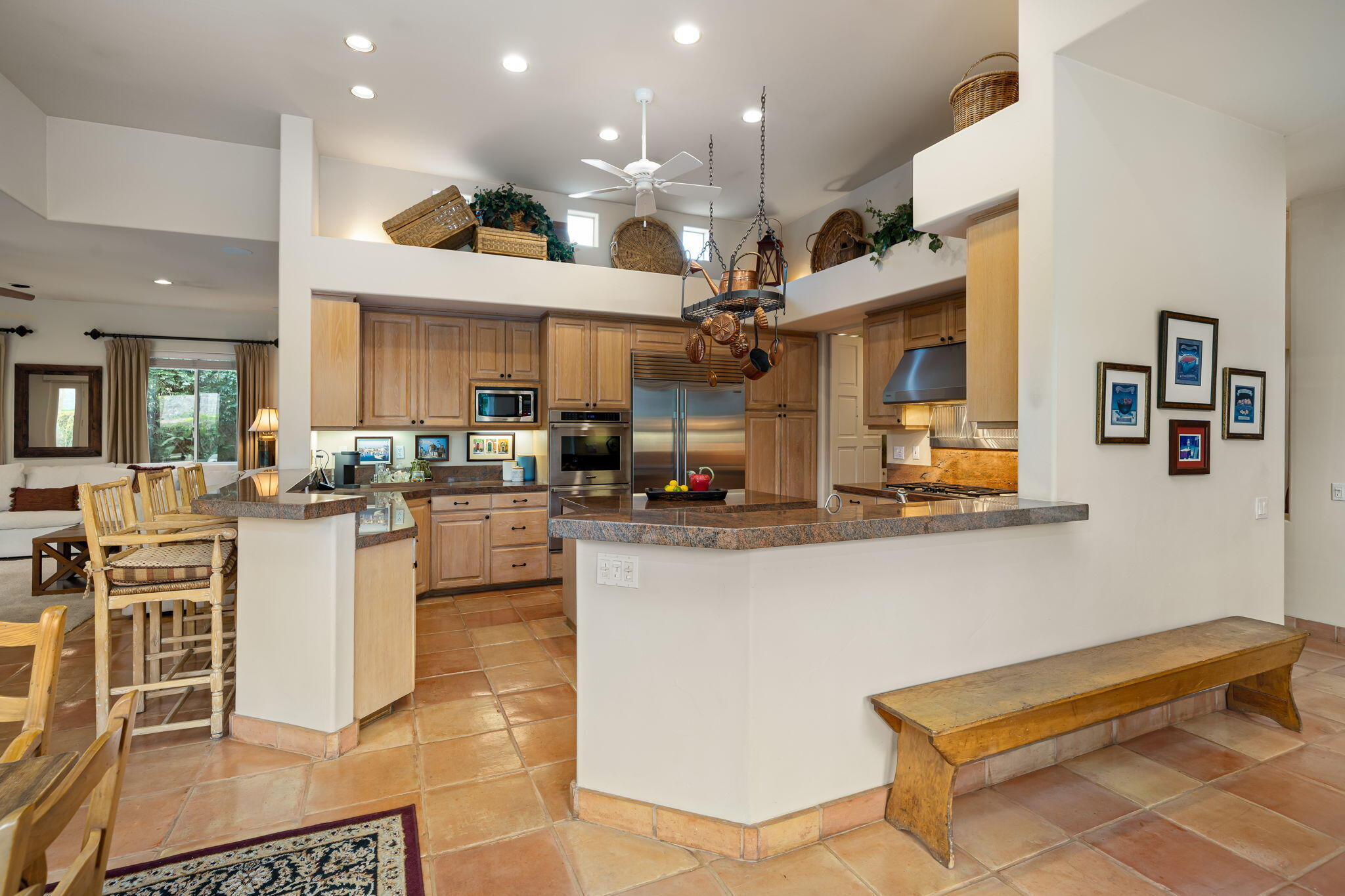 45595 Apache Road Indian Wells, CA 92210 - Photo 21 of 58 a kitchen with stainless steel appliances kitchen island granite countertop a table and chairs in it