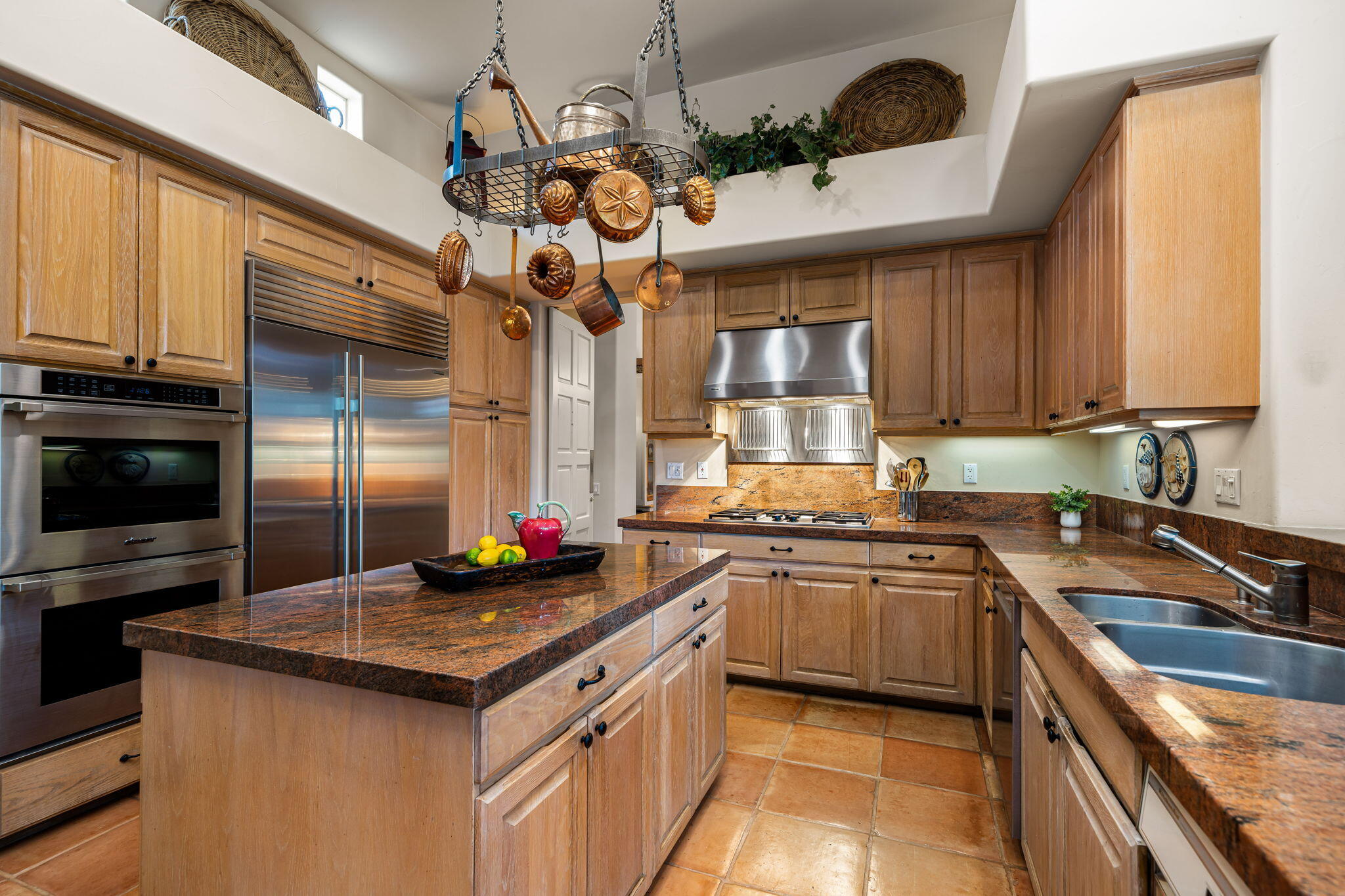 45595 Apache Road Indian Wells, CA 92210 - Photo 22 of 58 a kitchen with stainless steel appliances granite countertop a sink a stove and a wooden cabinets