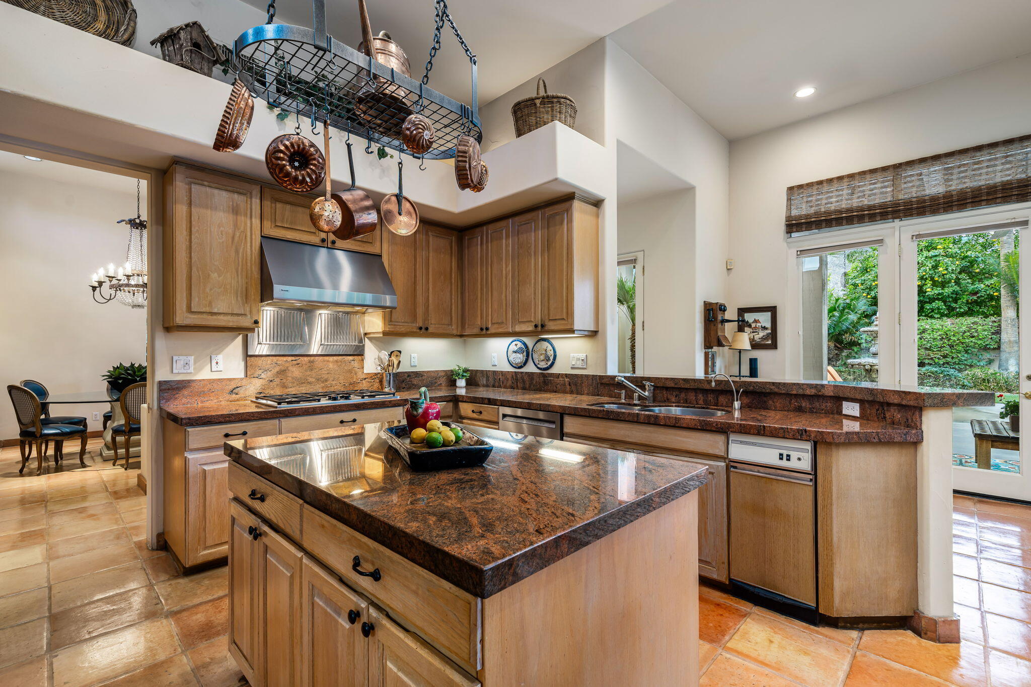 45595 Apache Road Indian Wells, CA 92210 - Photo 23 of 58 a kitchen with stainless steel appliances granite countertop a sink a stove and a wooden cabinets