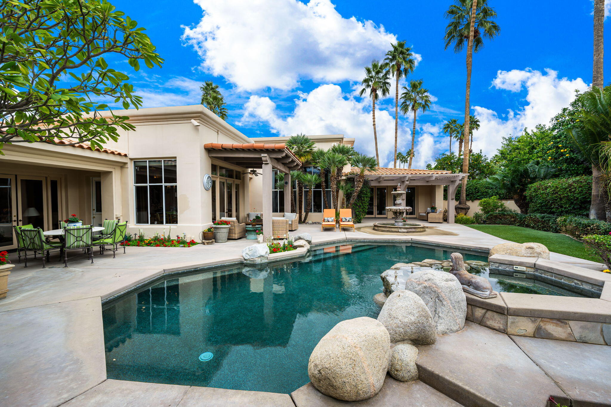 45595 Apache Road Indian Wells, CA 92210 - Photo 34 of 58 a view of house with swimming pool and outdoor seating