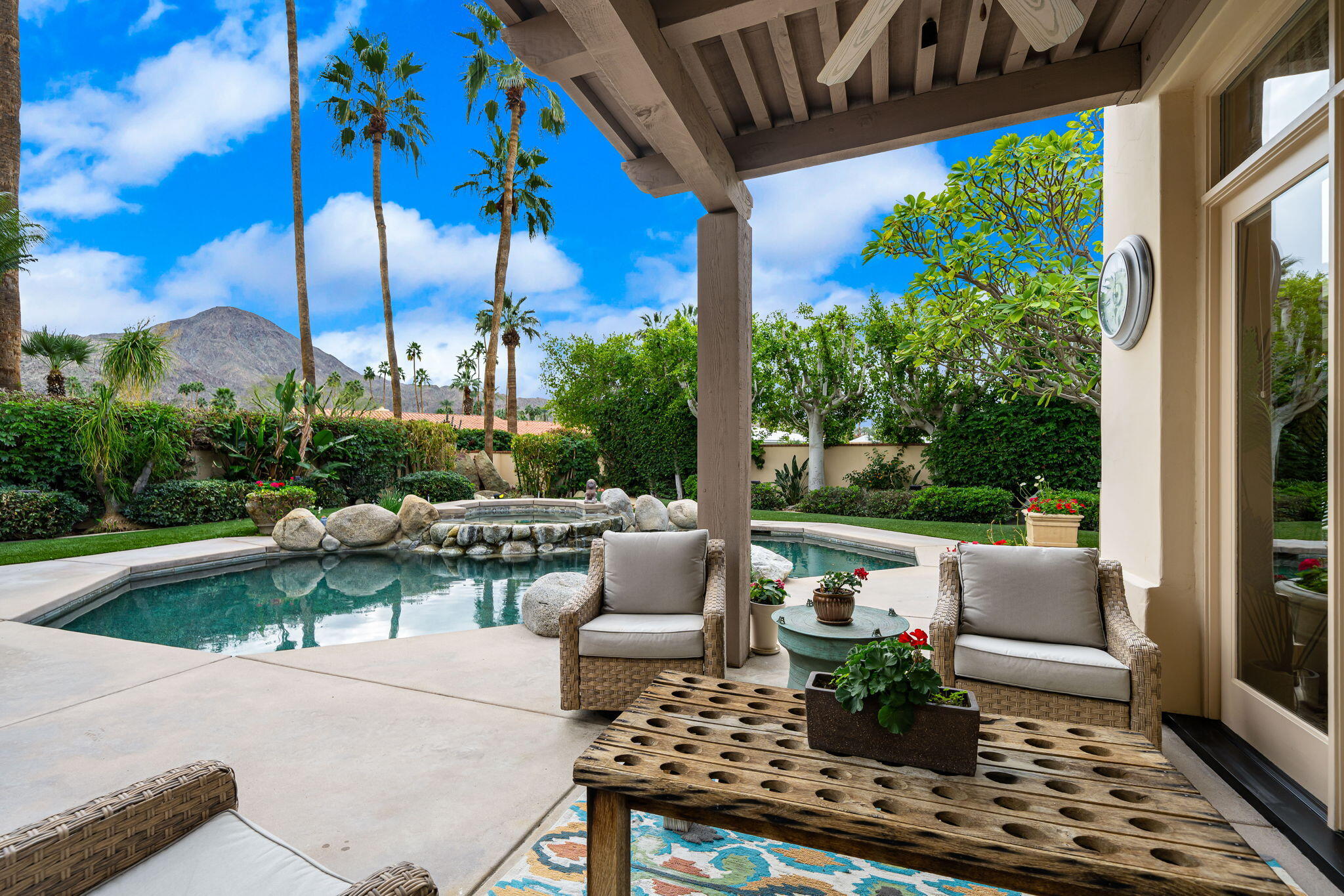 45595 Apache Road Indian Wells, CA 92210 - Photo 40 of 58 a view of a patio with couches and a table and chairs with garden view