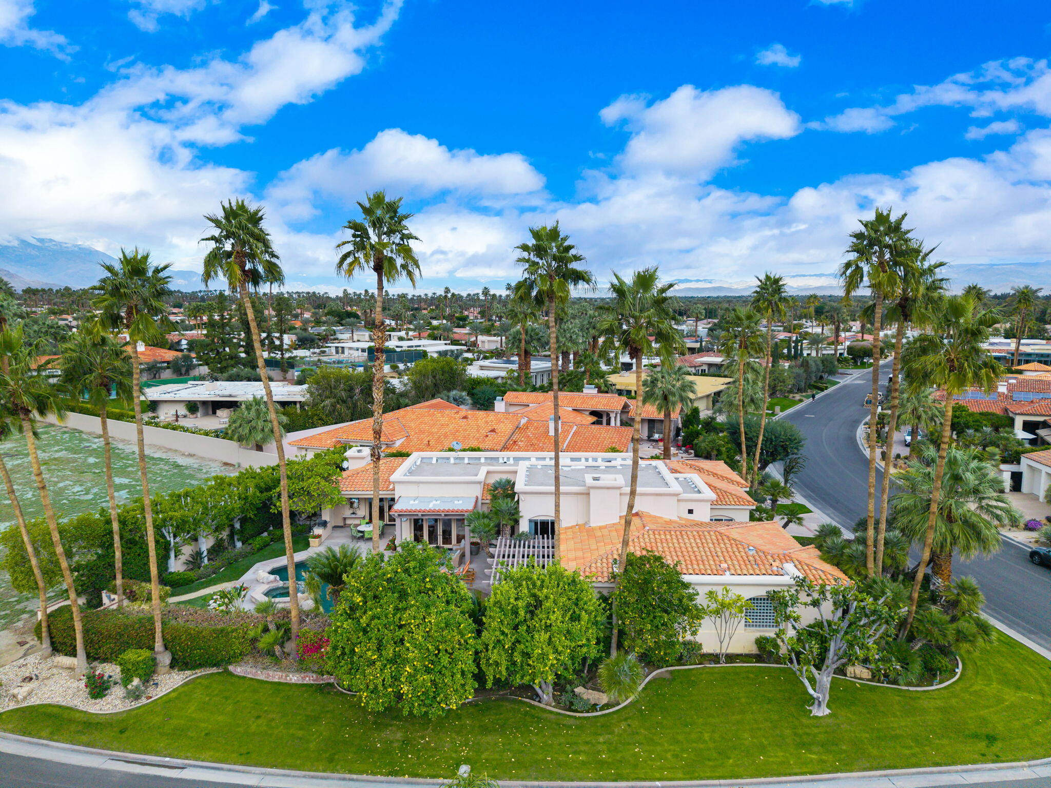 45595 Apache Road Indian Wells, CA 92210 - Photo 4 of 58 a view of a swimming pool with a yard