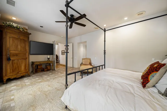 a bed room with a bed mirror and a window