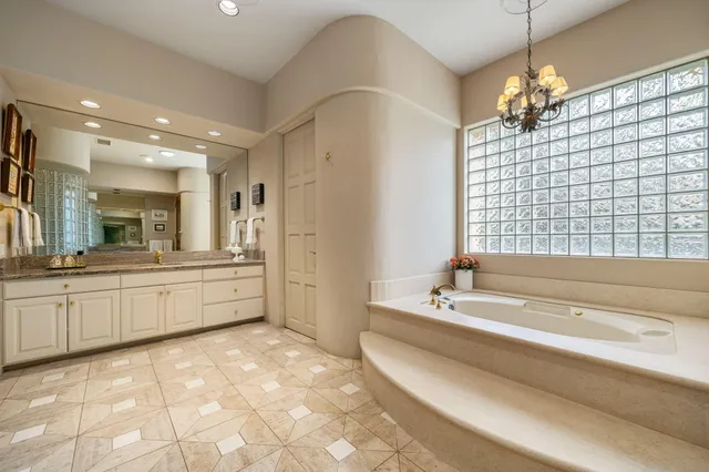 a bathroom with a toilet a sink a glass door a shower and a mirror