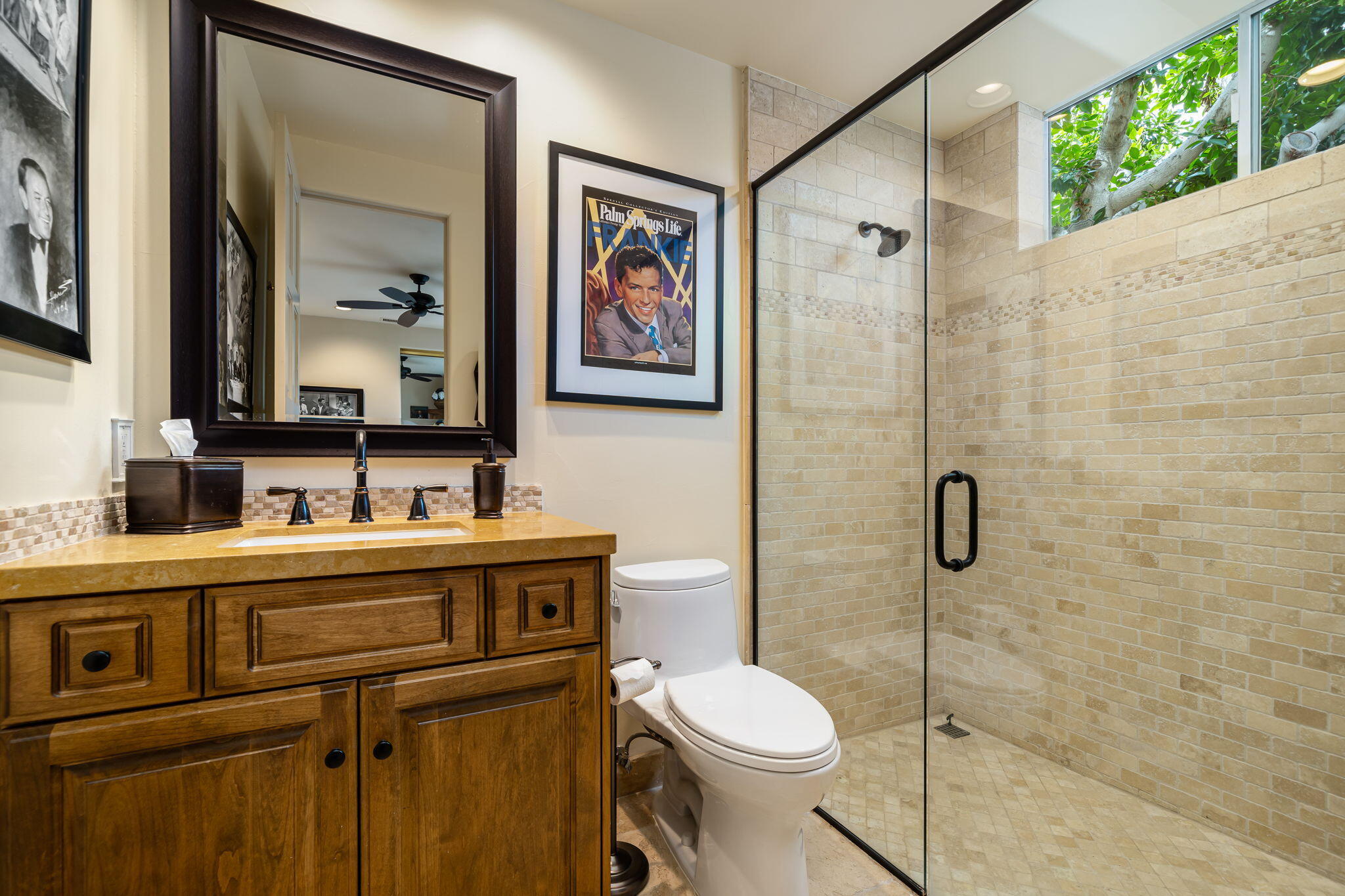 45595 Apache Road Indian Wells, CA 92210 - Photo 56 of 58 a bathroom with a toilet a sink a glass door a shower and a mirror