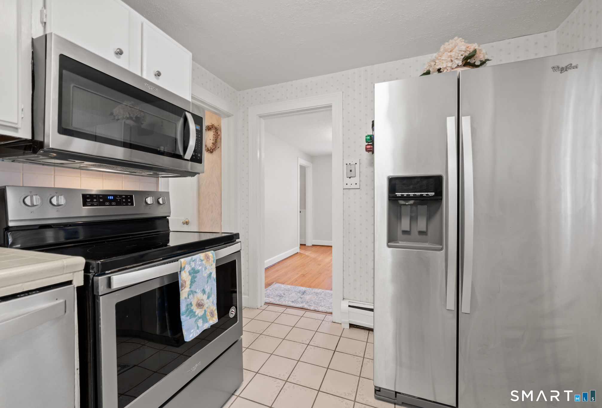 164 St John Street Manchester, CT 06040 - Photo 11 of 34 The kitchen, with tile floor, is open to the dining room.
