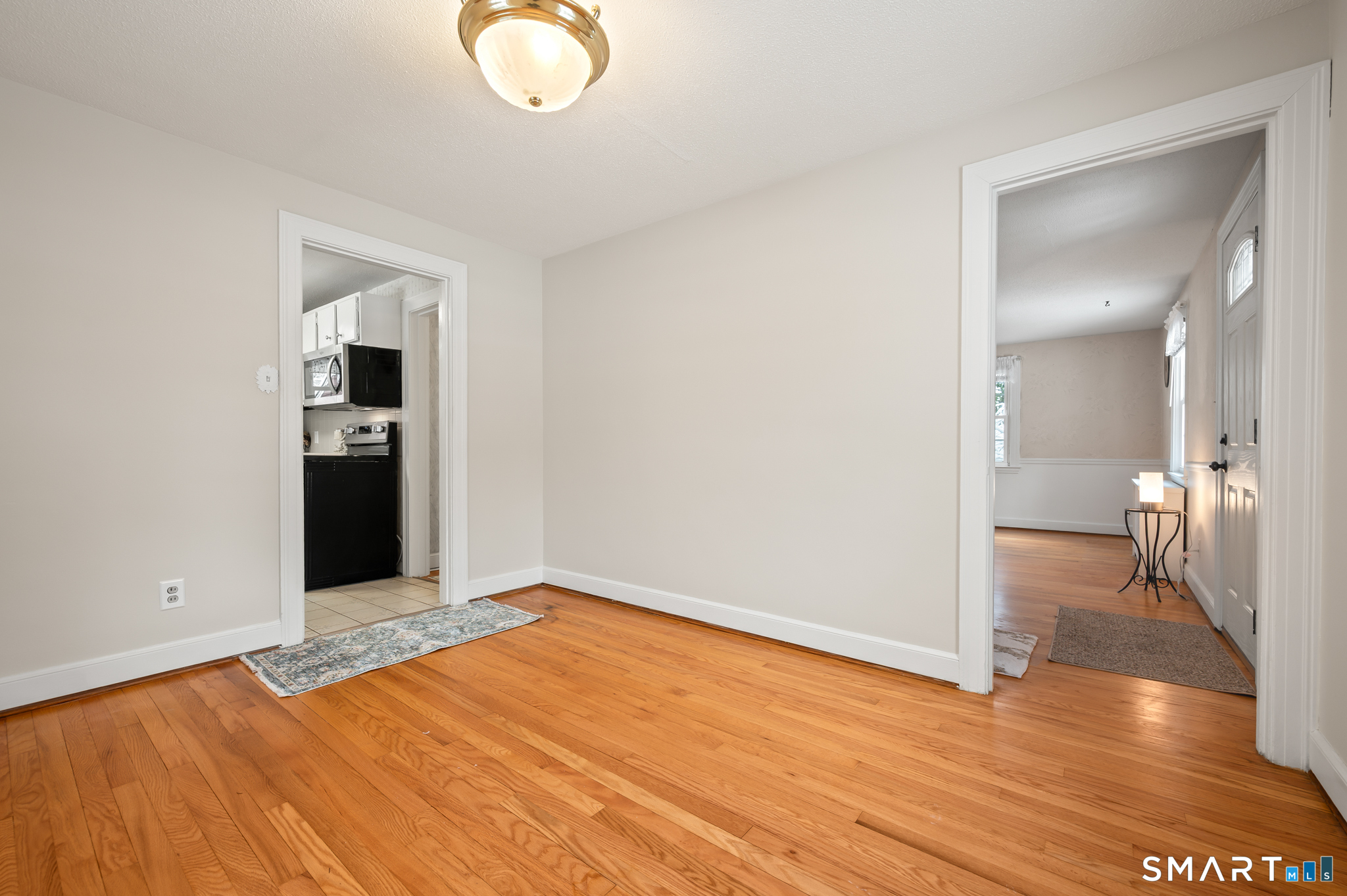164 St John Street Manchester, CT 06040 - Photo 12 of 34 View of dining room with hardwood floors, looking towards the front door, living room and kitchen.