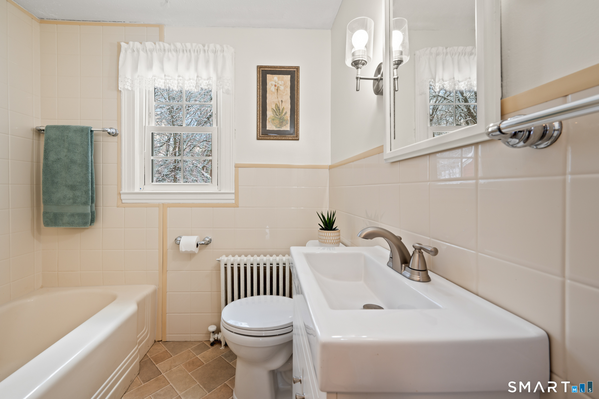 164 St John Street Manchester, CT 06040 - Photo 18 of 34 The full bathroom has a new vanity, lighting, plumbing fixtures and tile floor.