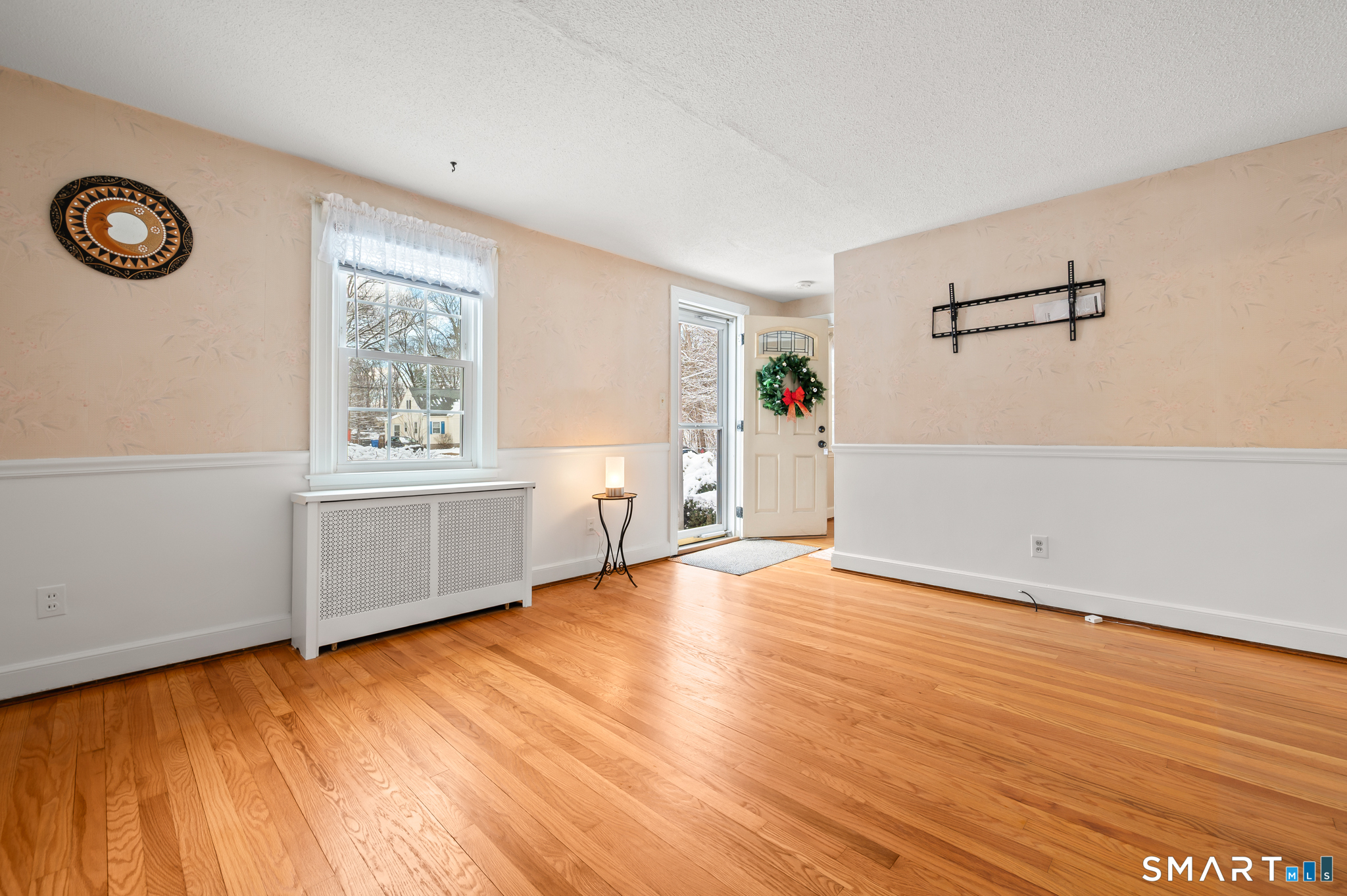 164 St John Street Manchester, CT 06040 - Photo 5 of 34 The living room has hardwood flooring, in "like new" condition and chair rail.