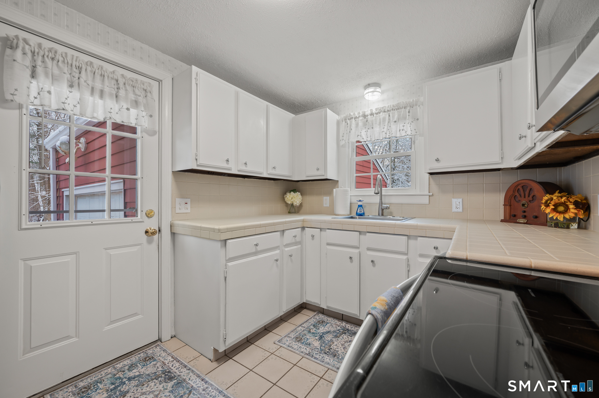 164 St John Street Manchester, CT 06040 - Photo 10 of 34 Kitchen door leads to the driveway and garage.