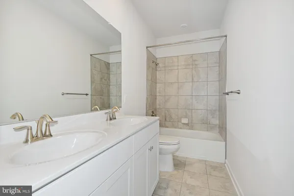 a bathroom with a bathtub shower sink and toilet