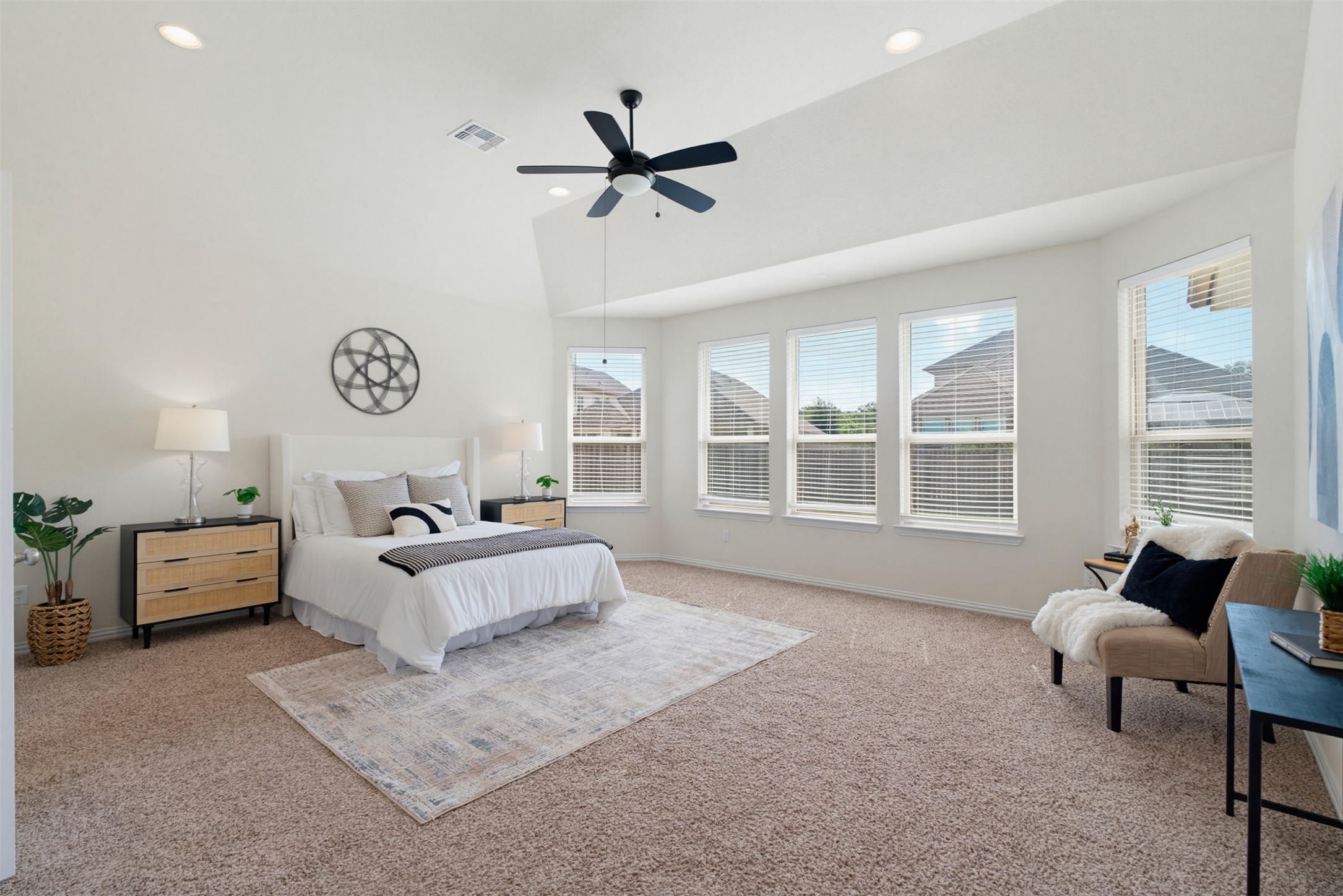 12613 Twisted Root Drive Manchaca, TX 78652 - Photo 10 of 33 Well-lit and tranquil, this primary bedroom features vaulted ceilings, ample natural light, and plush carpeting.