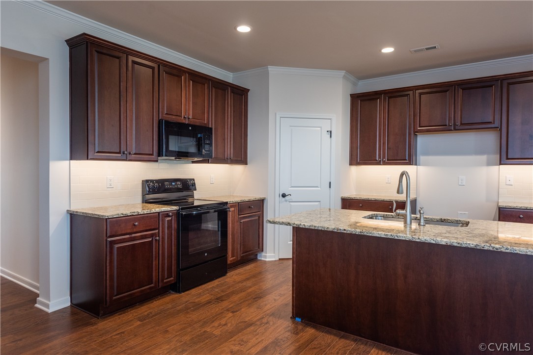 7411 Indian River Run Henrico, VA 23231 - Photo 16 of 17 Kitchen with tasteful backsplash, dark hardwood /