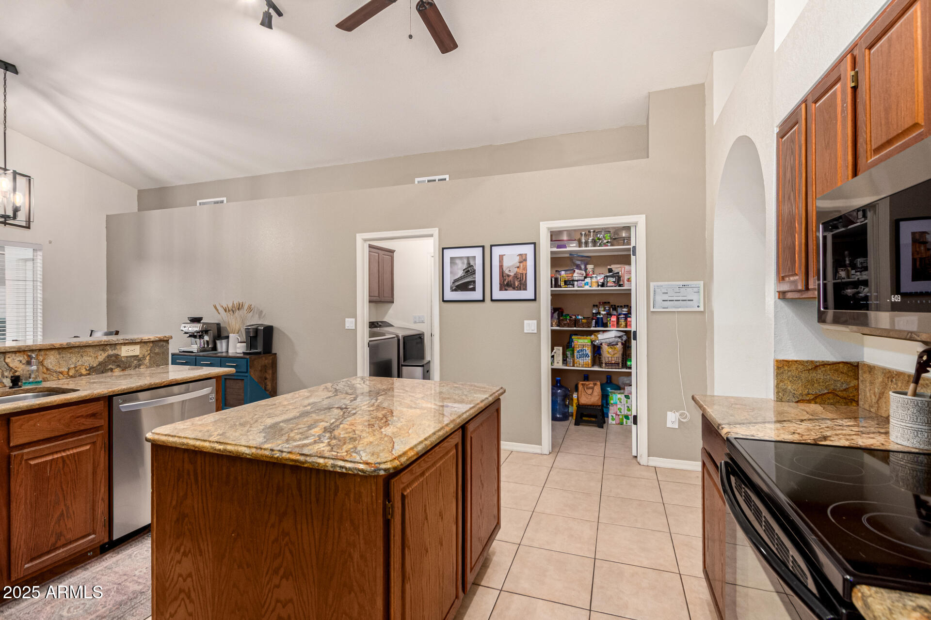 2646 North Robin Lane Mesa, AZ 85213 - Photo 11 of 45 a kitchen with stainless steel appliances granite countertop a stove and a sink