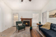 2646 North Robin Lane Mesa, AZ 85213 - Photo 19 of 45 a living room with furniture and a fireplace