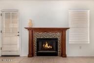 2646 North Robin Lane Mesa, AZ 85213 - Photo 20 of 45 a living room with furniture and a fireplace