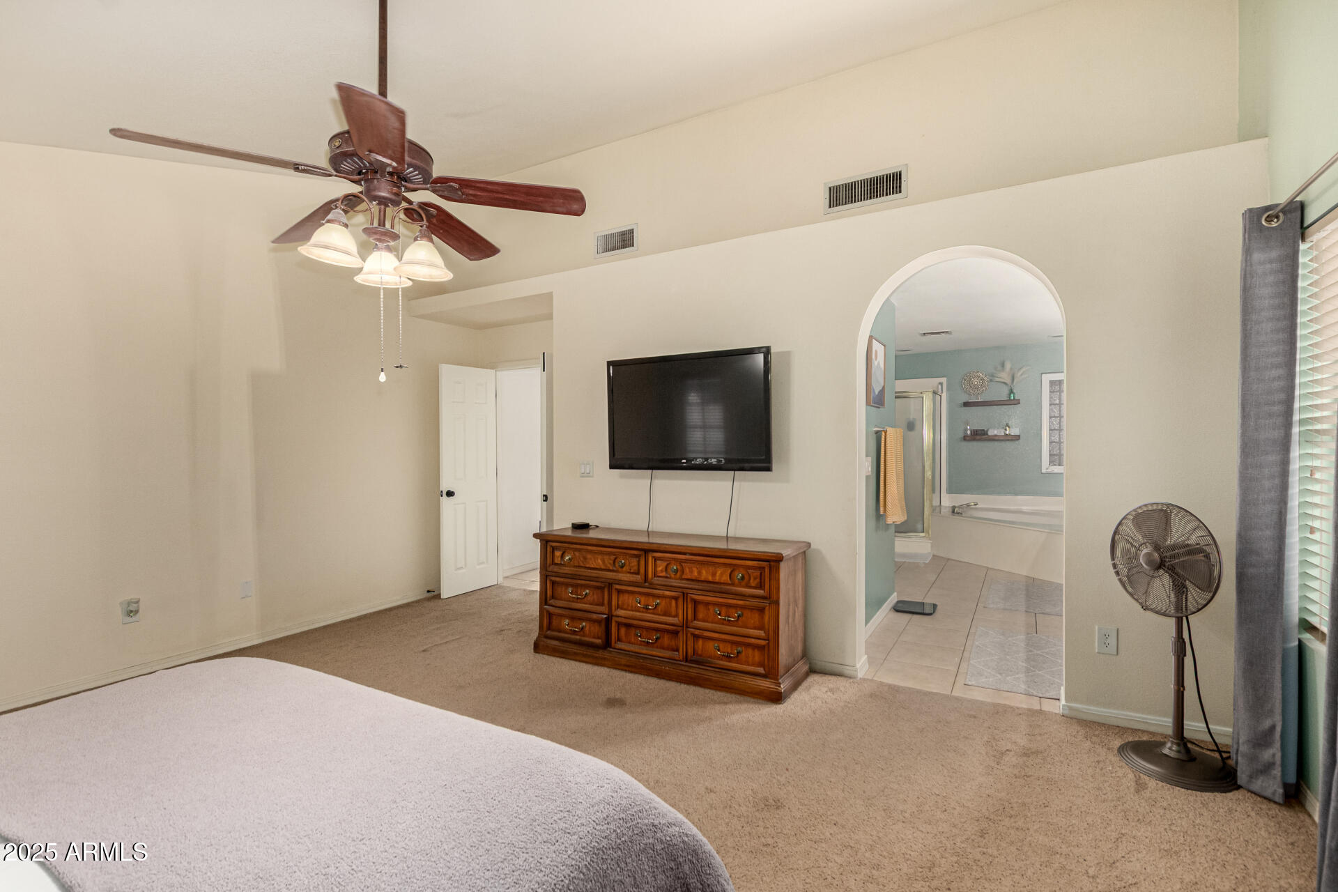 2646 North Robin Lane Mesa, AZ 85213 - Photo 23 of 45 a bedroom with furniture and a flat screen tv