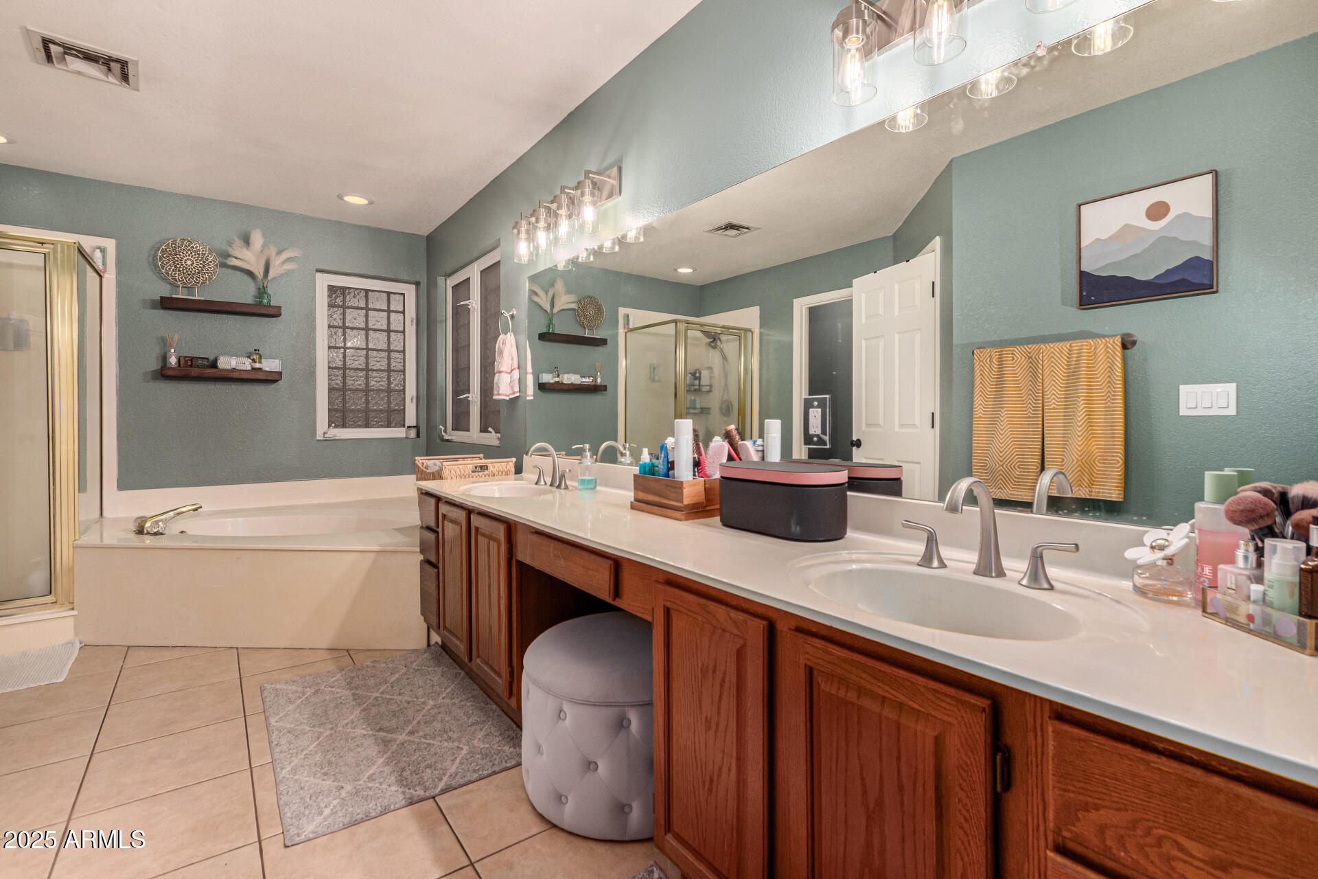 2646 North Robin Lane Mesa, AZ 85213 - Photo 24 of 45 a bathroom with a tub sink and mirror