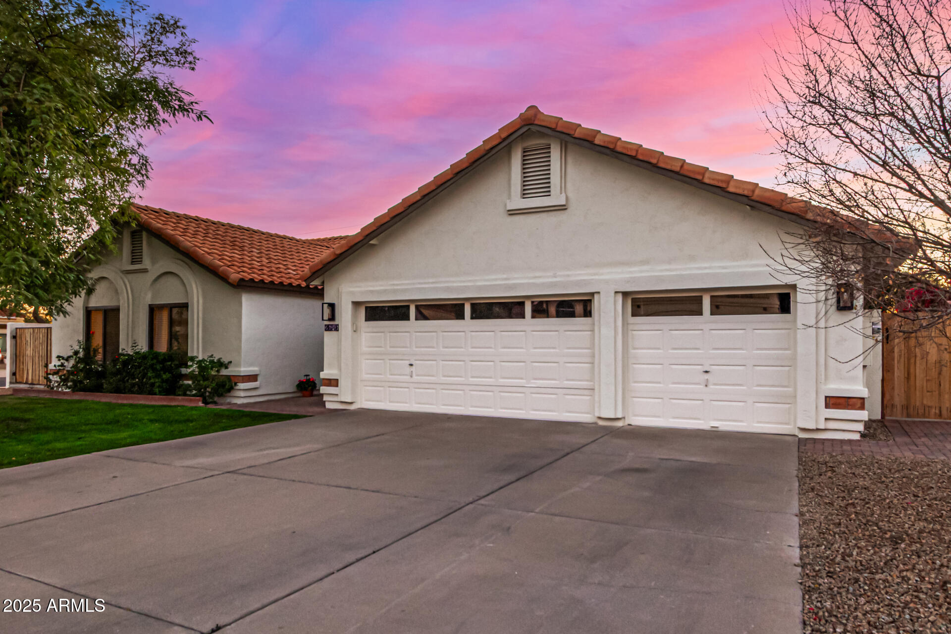 2646 North Robin Lane Mesa, AZ 85213 - Photo 3 of 45 a front view of a house with a yard and garage