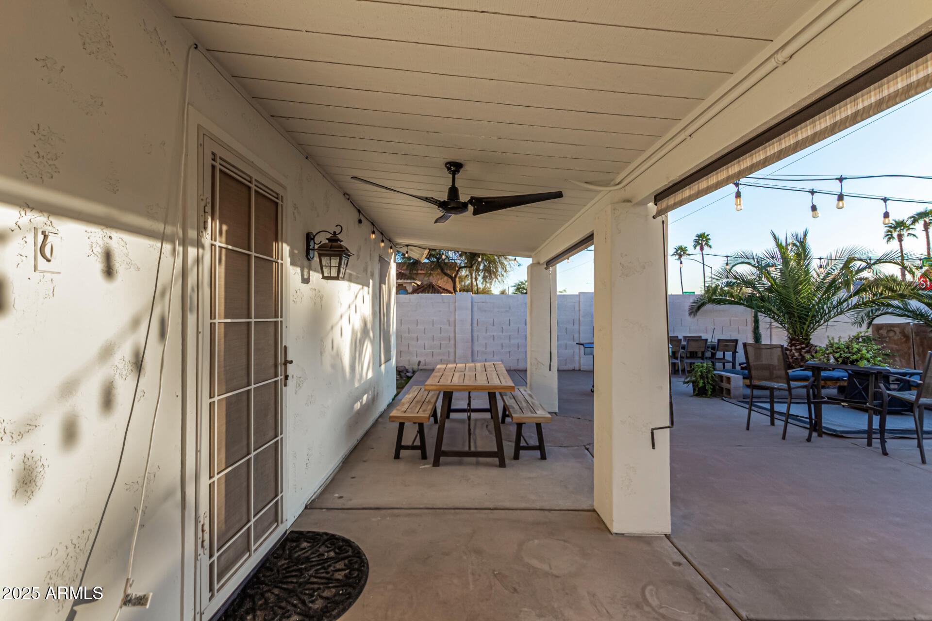 2646 North Robin Lane Mesa, AZ 85213 - Photo 40 of 45 a view of a patio with table and chairs potted plants and a palm tree