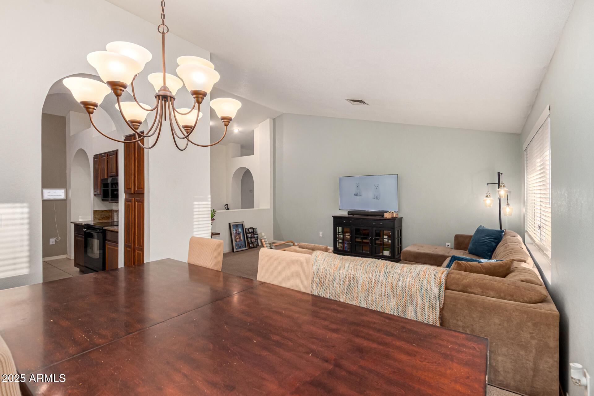2646 North Robin Lane Mesa, AZ 85213 - Photo 10 of 45 a living room with furniture chandelier and fireplace