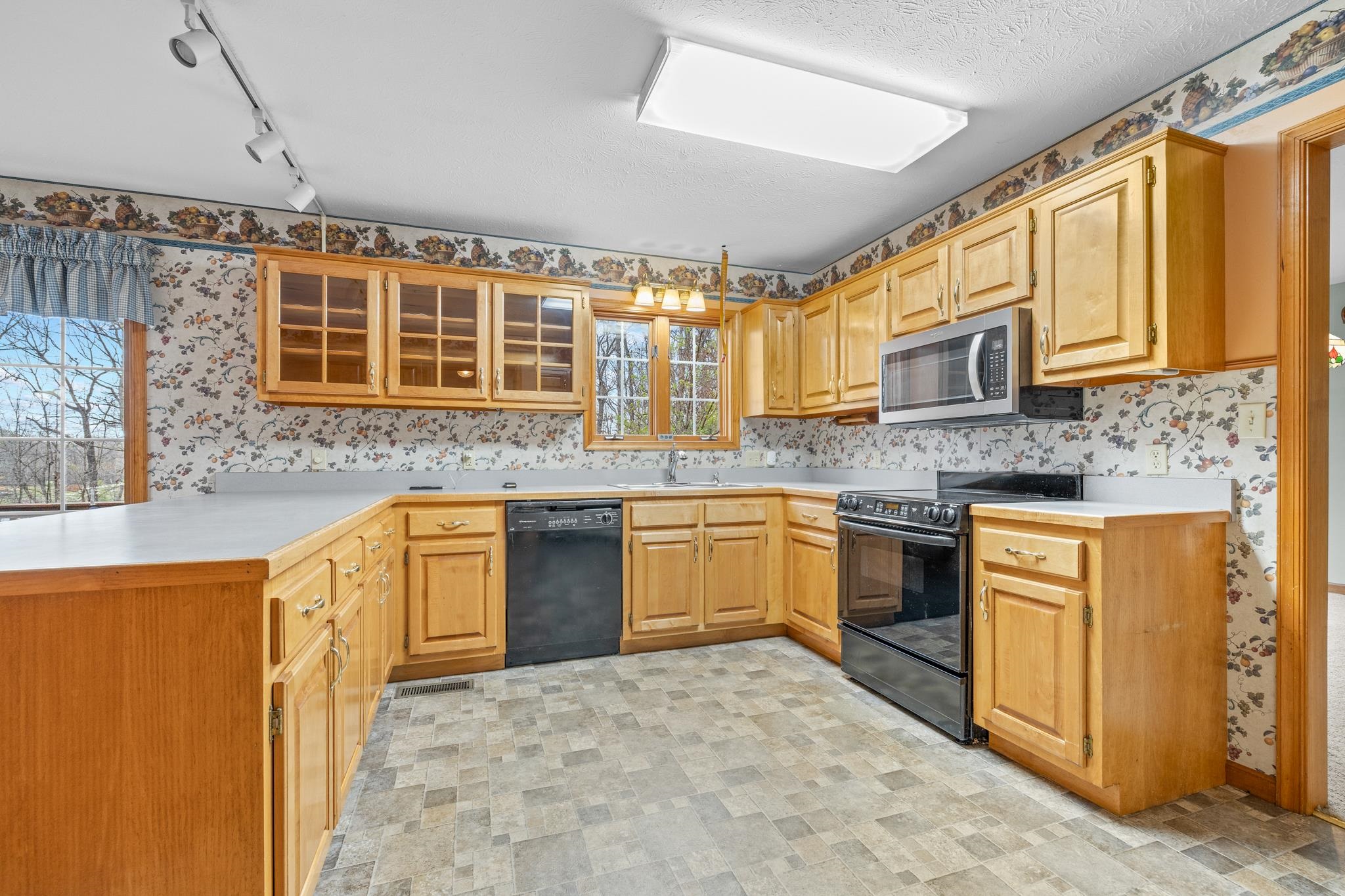 333 Cranberry Drive Stuarts Draft, VA 24477 - Photo 12 of 48 a kitchen with stainless steel appliances granite countertop a stove a sink dishwasher and a microwave oven with white cabinets