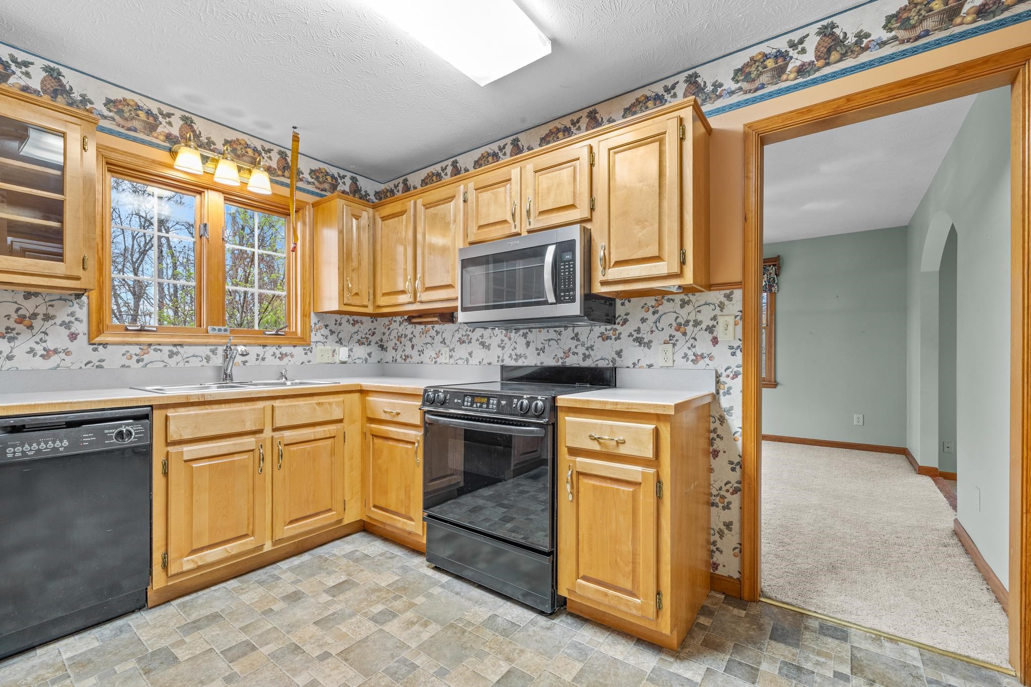 333 Cranberry Drive Stuarts Draft, VA 24477 - Photo 13 of 48 a kitchen with stainless steel appliances granite countertop a sink stove and microwave
