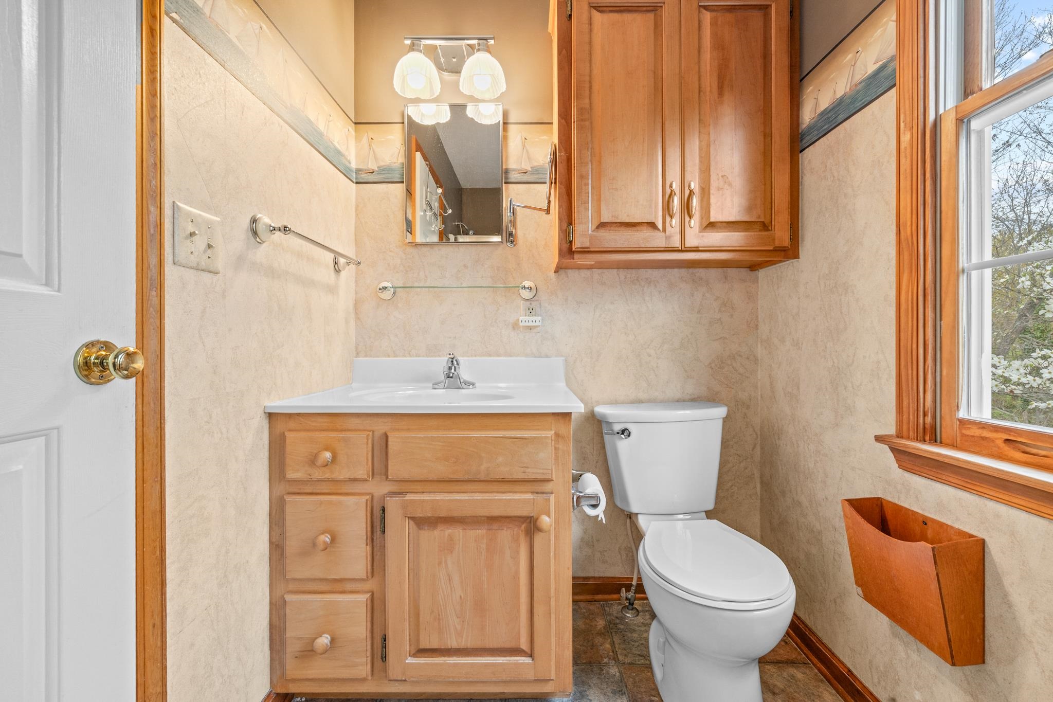 333 Cranberry Drive Stuarts Draft, VA 24477 - Photo 43 of 48 a bathroom with a toilet sink and mirror with window