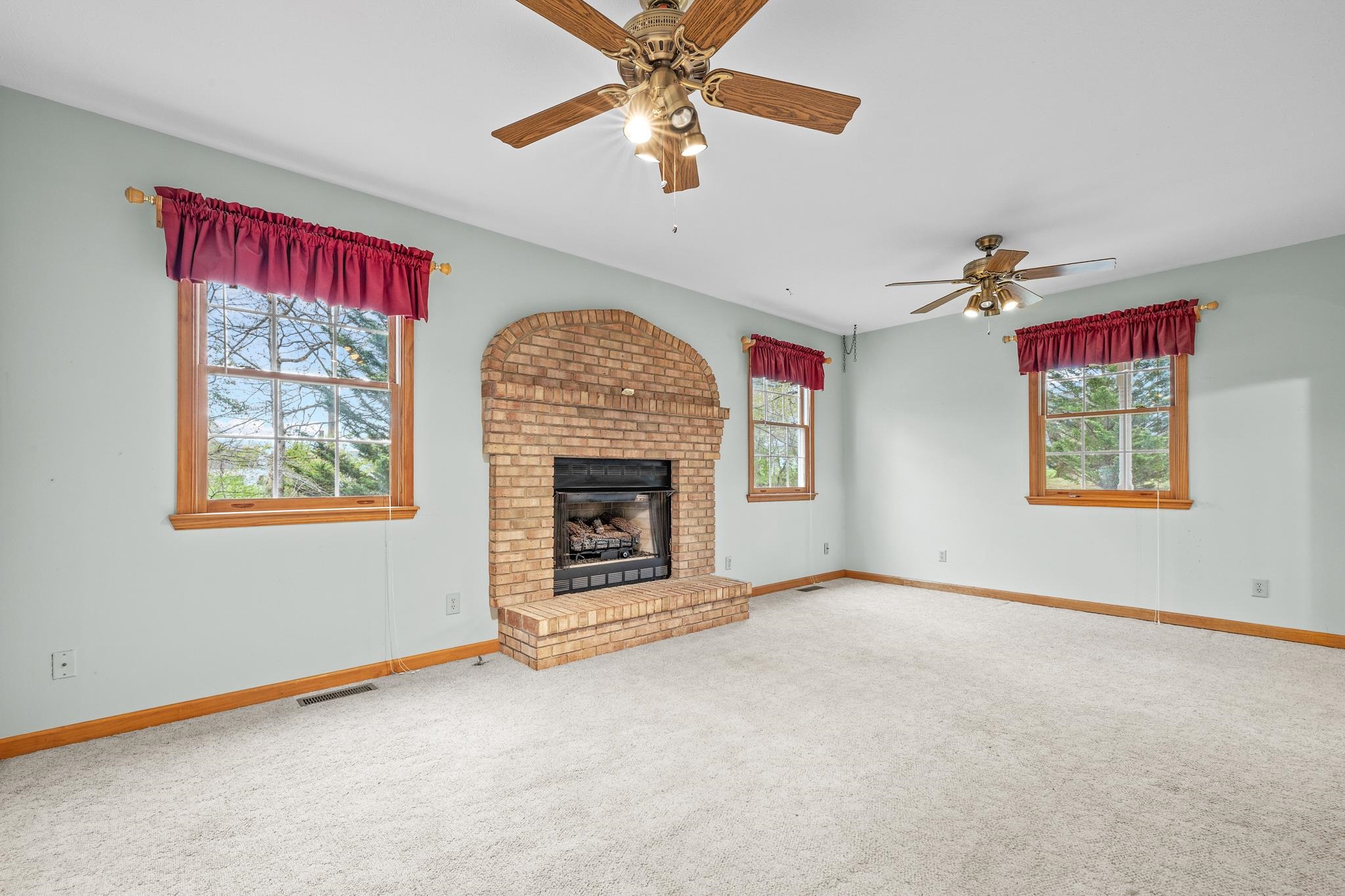 333 Cranberry Drive Stuarts Draft, VA 24477 - Photo 8 of 48 an empty room with windows and fireplace