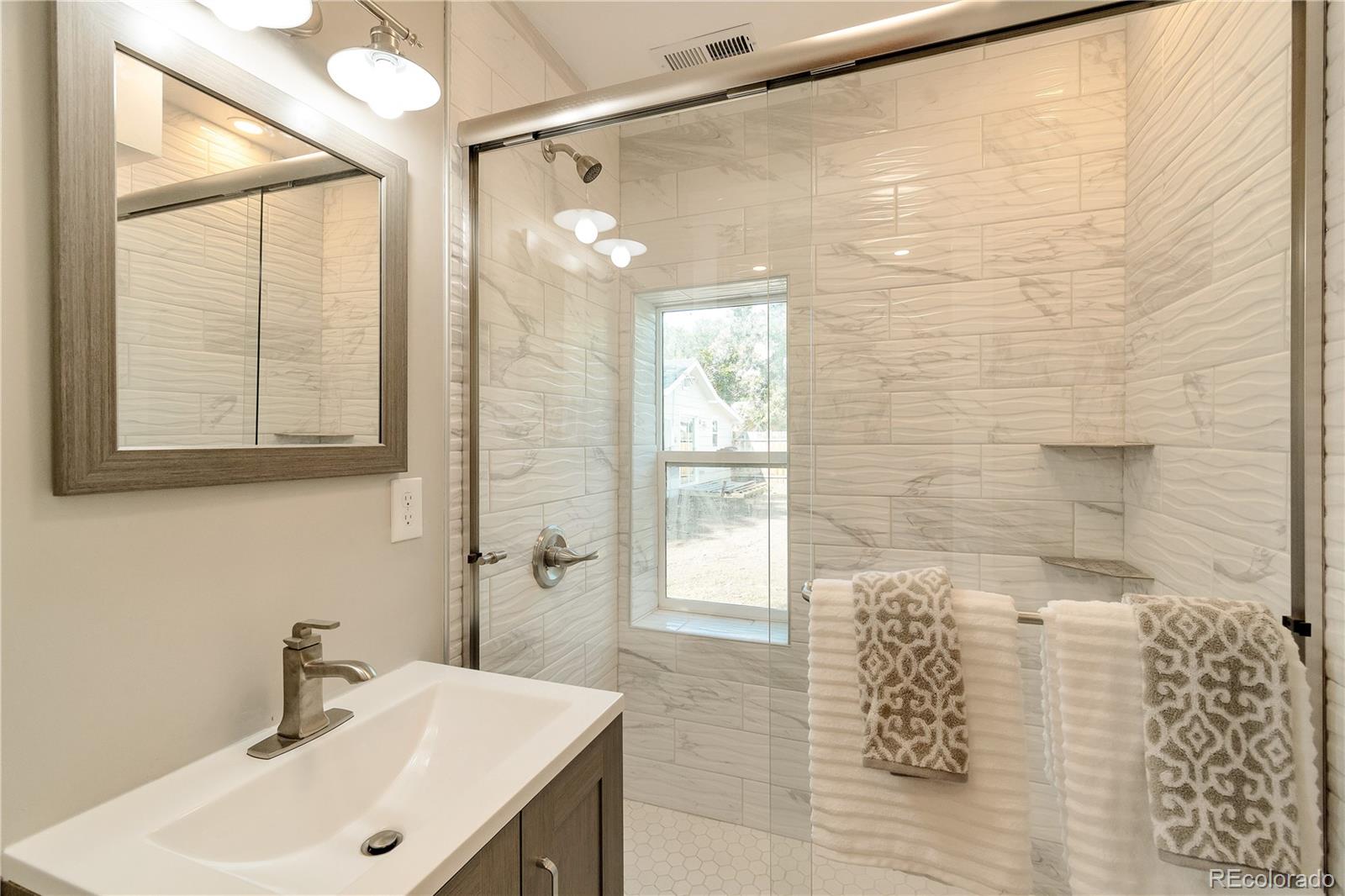2868 Benton Street Wheat Ridge, CO 80214 - Photo 17 of 22 a bathroom with a sink and shower