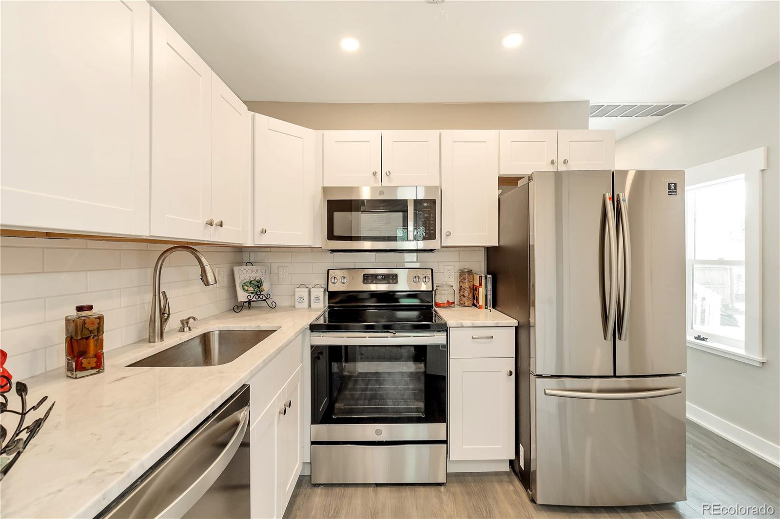 2868 Benton Street Wheat Ridge, CO 80214 - Photo 18 of 22 a kitchen with a refrigerator stove and sink