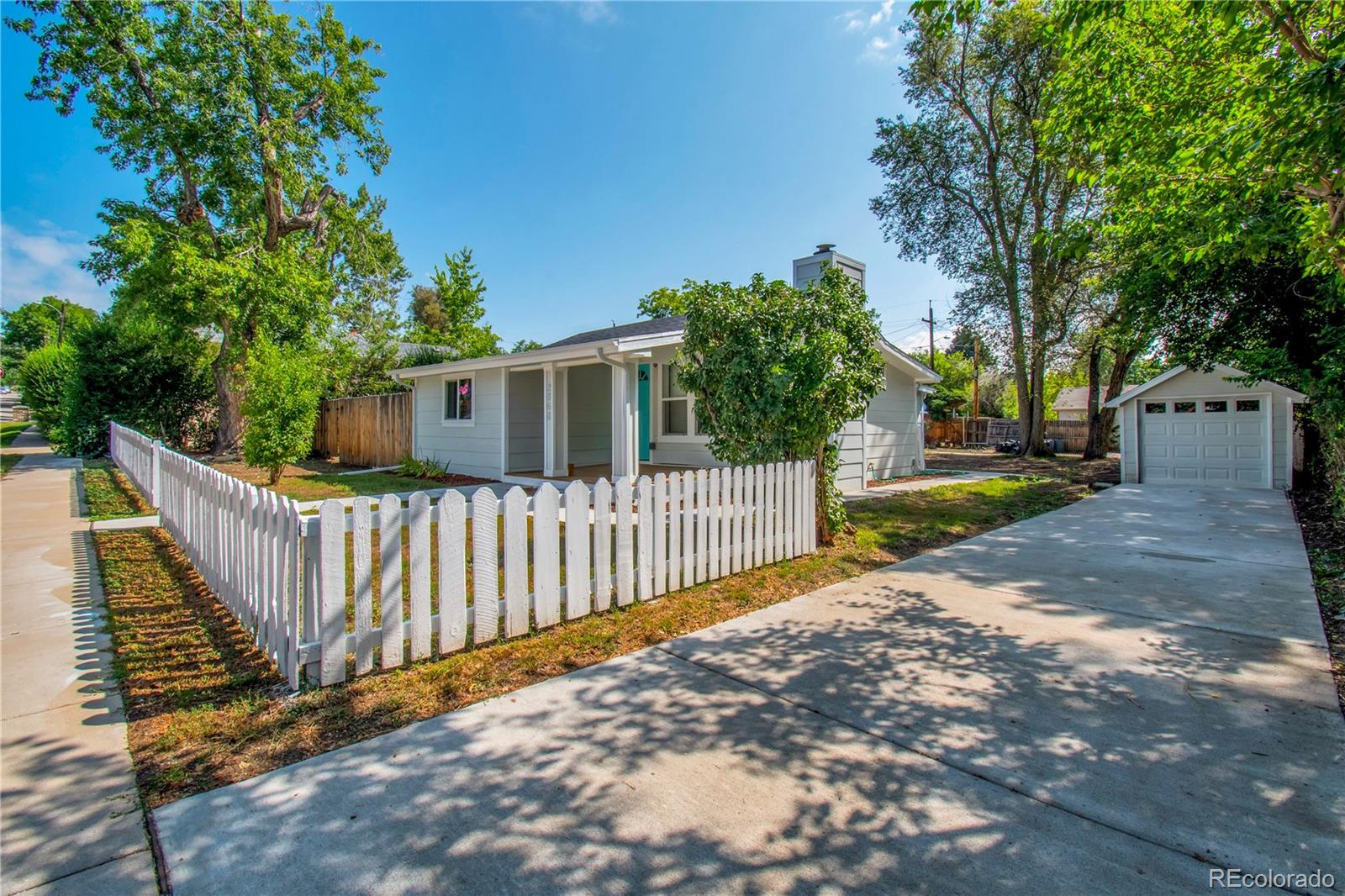 2868 Benton Street Wheat Ridge, CO 80214 - Photo 20 of 22 a view of a small yard and wooden fence