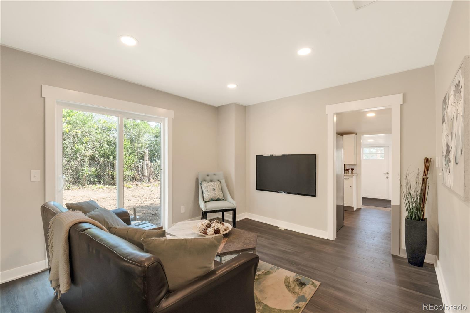 2868 Benton Street Wheat Ridge, CO 80214 - Photo 3 of 22 a living room with furniture and a flat screen tv