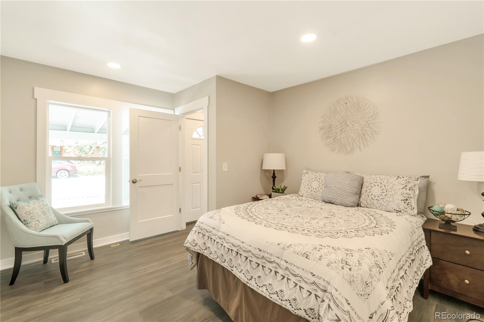 2868 Benton Street Wheat Ridge, CO 80214 - Photo 6 of 22 a large bedroom with a bed and wooden floor
