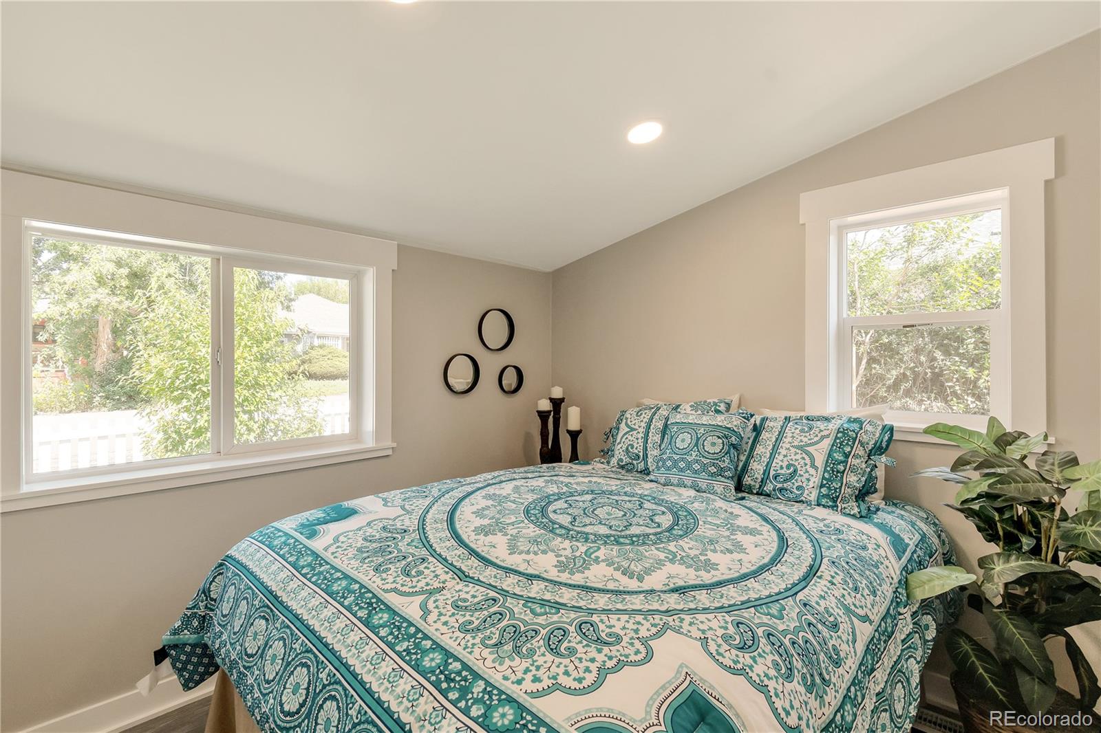 2868 Benton Street Wheat Ridge, CO 80214 - Photo 9 of 22 a bed sitting in a bedroom next to a window
