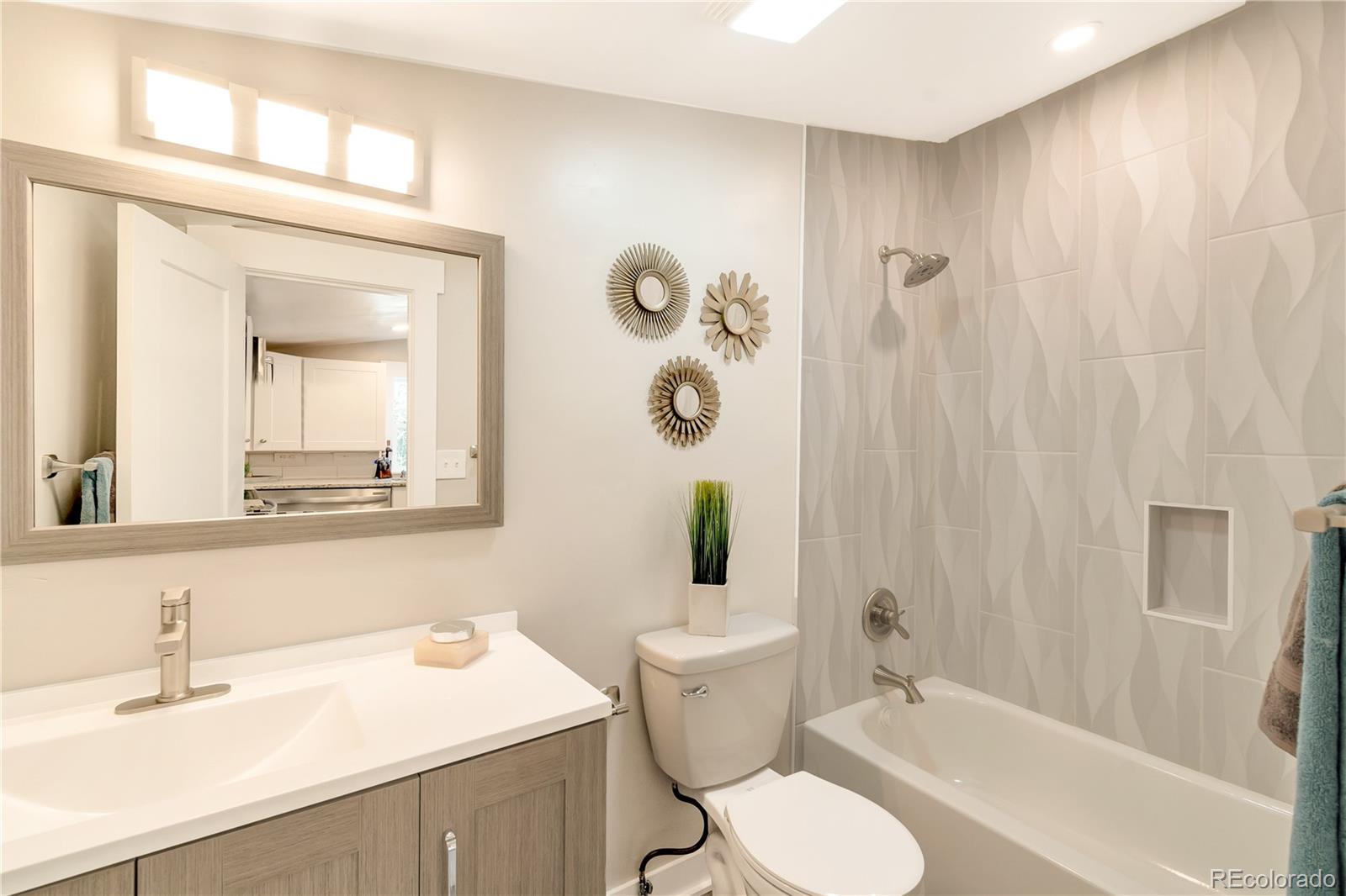 2868 Benton Street Wheat Ridge, CO 80214 - Photo 10 of 22 a bathroom with a sink vanity mirror and toilet