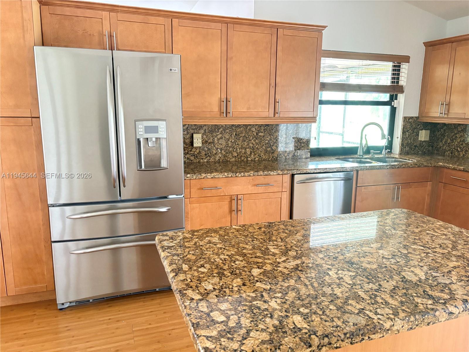21374 Summertrace Circle Boca Raton, FL 33428 - Photo 2 of 14 a kitchen with granite countertop a refrigerator and a stove top oven