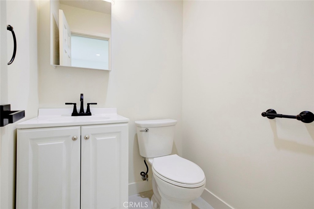 9917 Marcus Avenue, Unit 9917 Tujunga, CA 91042 - Photo 11 of 32 a bathroom with a sink a toilet and a mirror