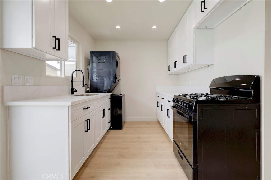 9917 Marcus Avenue, Unit 9917 Tujunga, CA 91042 - Photo 12 of 32 a kitchen with stainless steel appliances granite countertop a stove a sink and a refrigerator